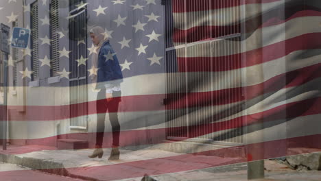 animation of american flag waving over biracial woman in hijab walking in city street