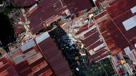 Top-down-vertical-aerial-drone-footage-showing-massive-plastic-pollution-on-a-floating-village-in-Cambodia