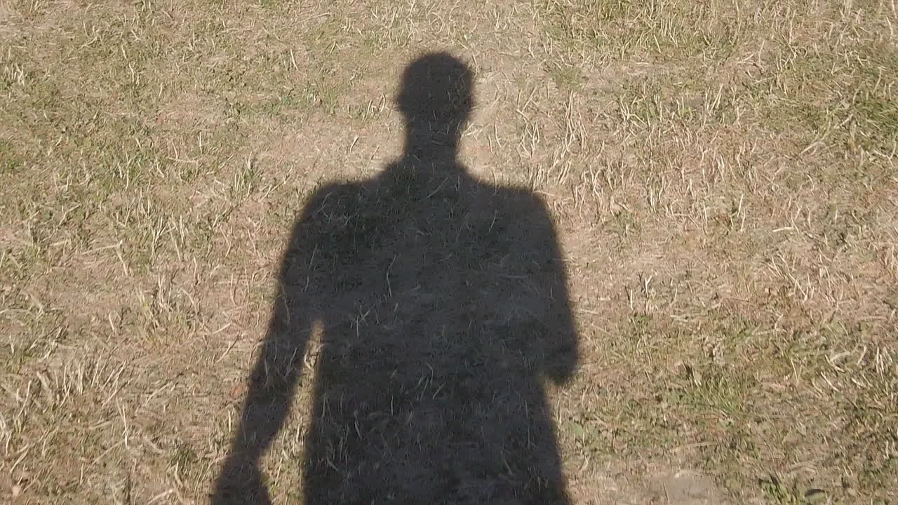 마른 풀 위에서 슬로우 모션으로 걷는 그림자 인간, 기후 변화로 인한 유럽의 건조한 여름