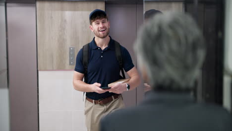 delivery man handing package to customer