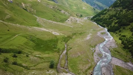 aerial of a river through the countryside in the republic of georgia