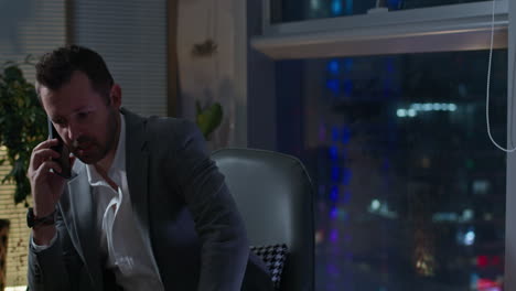 businessman talking on phone at night