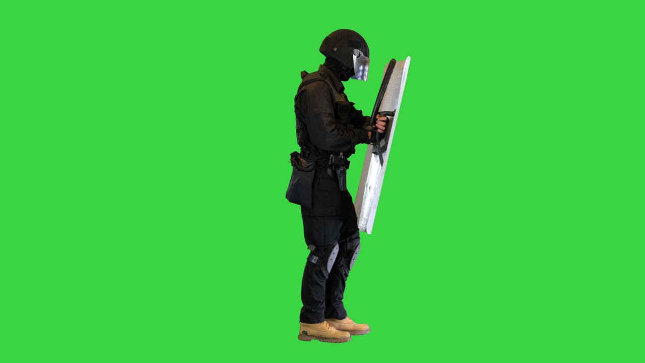 Riot police unit walking with the shield up on a Green Screen, Chroma Key