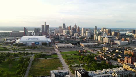aerial forwarding shot of urban green space, downtown detroit with comercia baseball park and ford football field