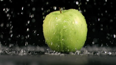 water raining on an apple in super slow motion