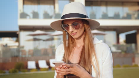 woman using phone at a luxury resort