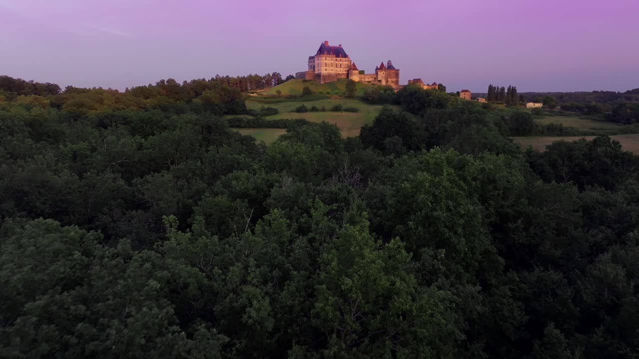 Castello di Biron nella regione della Dordogna con sfondo al tramonto, vista aerea