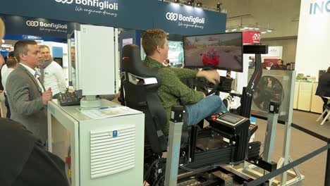 young men sitting in a racing simulator at the sps expo in nuremberg