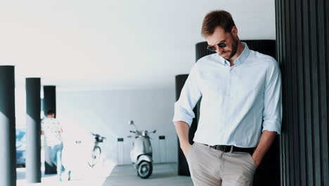 man in light blue shirt and sunglasses