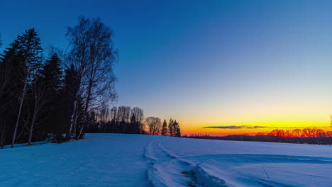 timelapse of colorful setting sun over snowy landscape at sunset