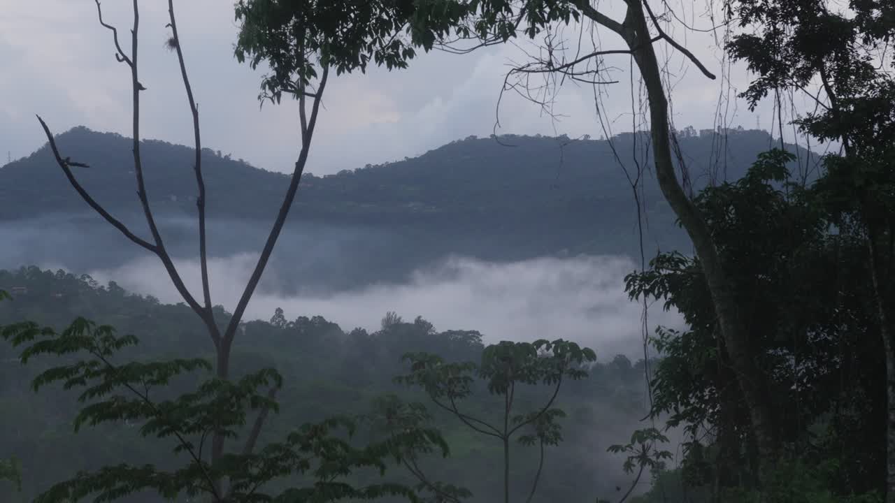 Scenic view of a mountainous hilly landscape covered in fog low-lying clouds