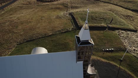 aerial orbit around modern lutheran church in rural iceland landscape