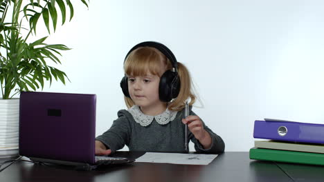 teen girl school student wearing wireless headphones calling teacher on laptop. distance education