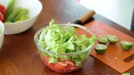 preparing a fresh salad with lime