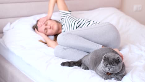 a young depressed woman lies on the bed with a cat 2023 12 20 07 09 53 utc.mov | awake, beautiful, bed, bedroom