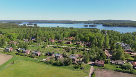 Panoramic-aerial-view-of-remote-Stjarnsund-village-in-lush-Swedish-countryside