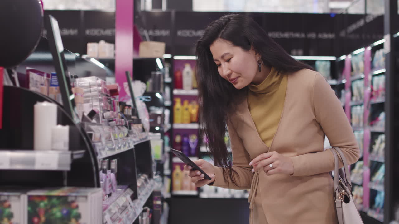 Woman Taking Shots On Smartphone In Make-Up Shop