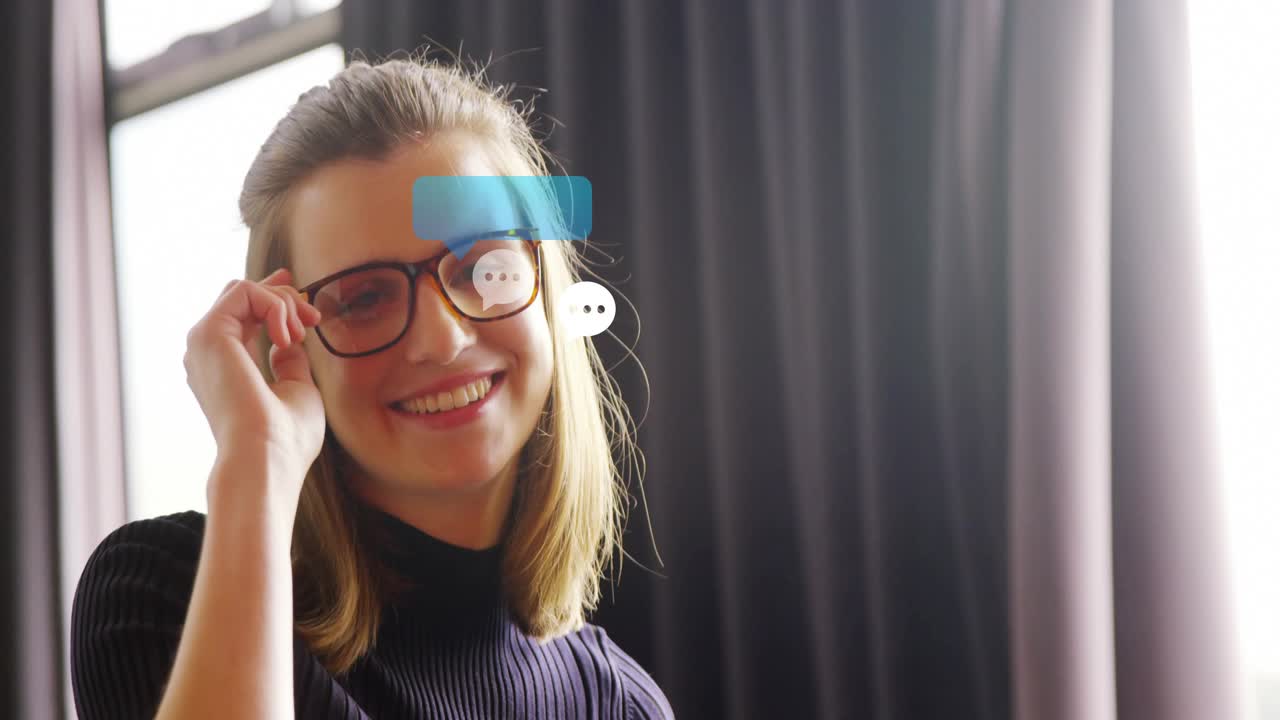 Woman tapping tablet and causing chat bubbles, reading chats in tech, smiling and adjusting glasses