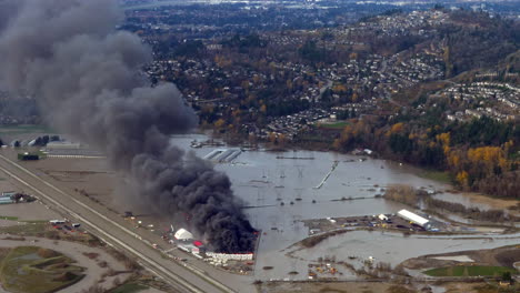 RV-Caravan-Vehicles-Burning-With-Black-Polluted-Smoke-Amidst-Devastating-Flood-In-Abbotsford,-BC,-Canada