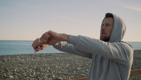 man stretching on the beach