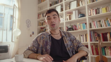 young man filming lifestyle vlog or video calling at home
