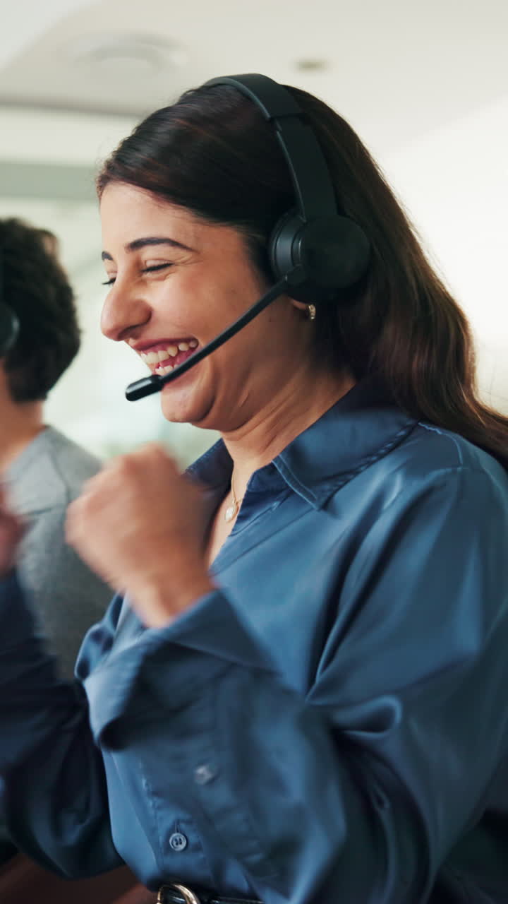 Happy Woman in Headset Celebrating Success in Call Center