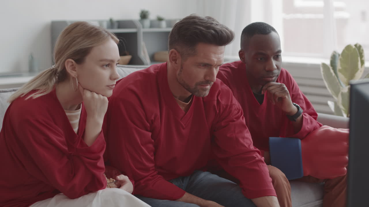 Football Fans Watching TV Quietly