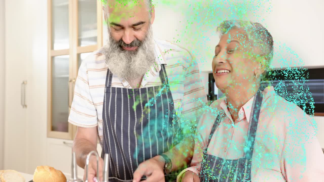 Couple starting cooking, woman chopping onion, man peeling at sink, particles appearing in front