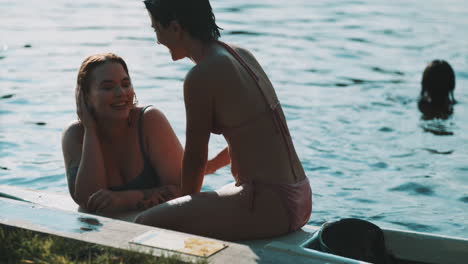 two women relaxing on a boat in the lake