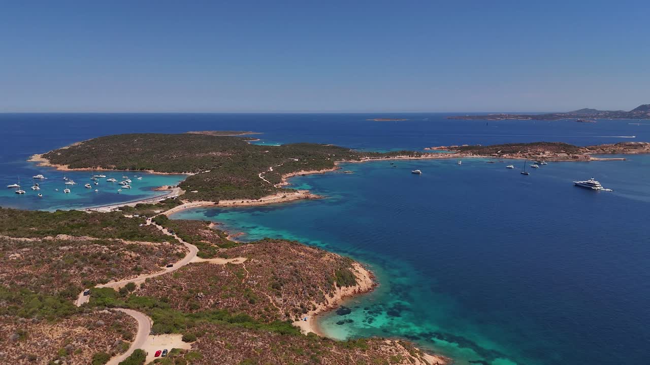 Stunning Sardinia beach lagoon with yachts, showcasing azure waters