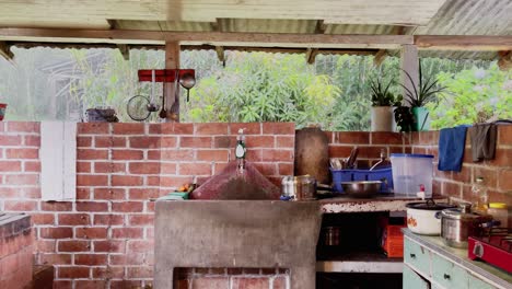 open style outdoor kitchen in peruvian jungle during rain downpour