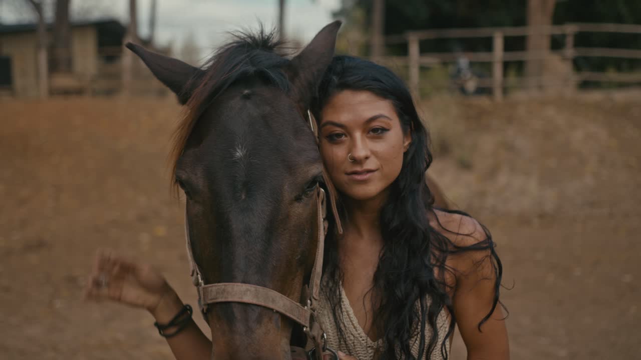 Young woman embracing her horse