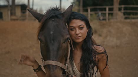 young woman embracing her horse