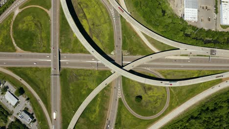 4k aerial view of cars and trucks on busy interstate highway exchange