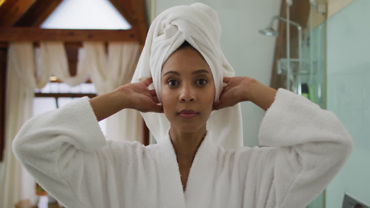 Portrait of mixed race woman wearing bathrobe looking at camera