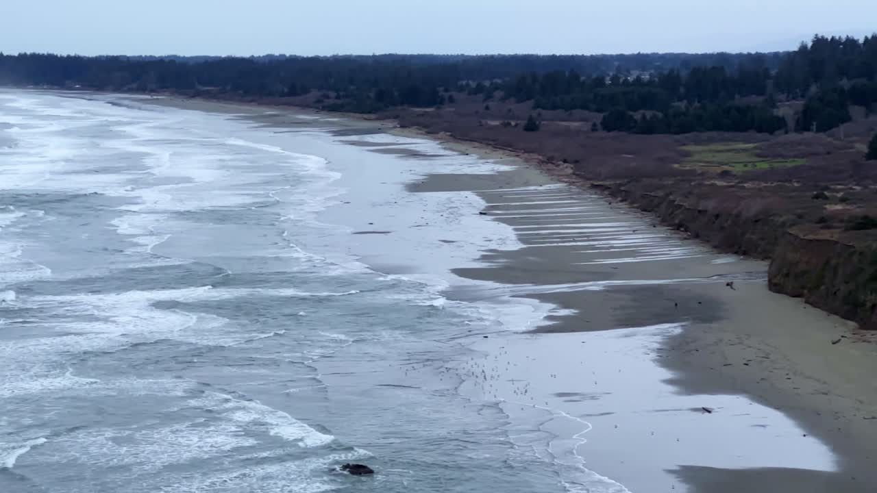 Handheld wide tilting up shot of Crescent Beach from the Crescent Beach Overlook on the coast of Northern California. 4K