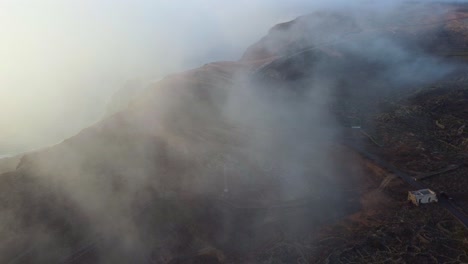light fog covered the corona volcano and the ye village in lanzarote island, spain. aerial