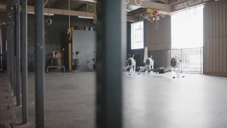 general view of empty fitness room at gym with exercise equipment, in slow motion