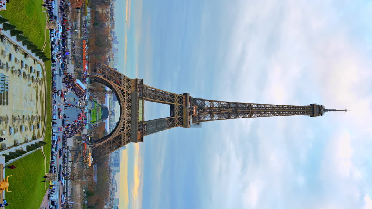 Vertical view of the Eiffel Tower in Paris from the Trocadero Square, France. Gardens of the Trocadero with people