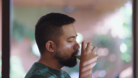 Man drinking a green tea