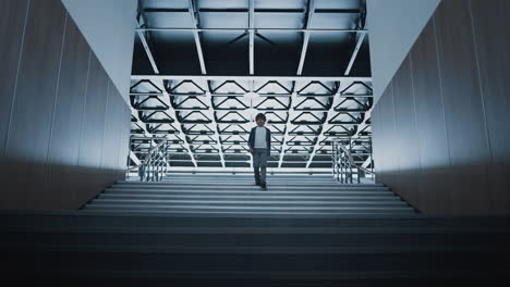 teenage schoolboy going downstairs alone. lonely child walking empty corridor.