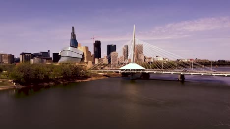 drone aerial over the red river showing the winnipeg manitoba skyline.