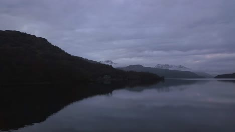 a low flight over a loch in scotland during the winter