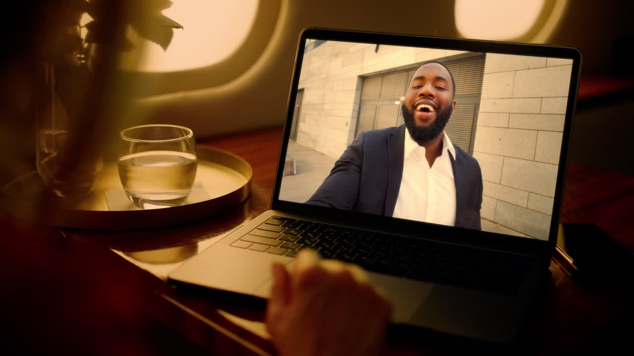 Woman virtual meeting laptop in plane closeup shoulder view. Lady talking online