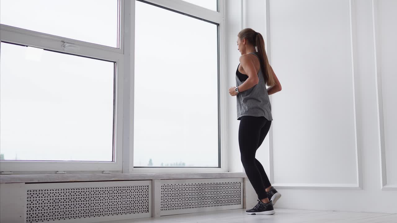 Woman exercising by a window