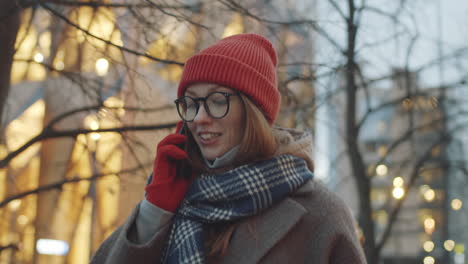 woman talking on phone in winter city