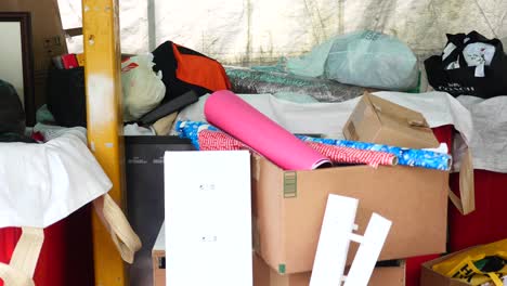 dumped donated items in a large container outdoor ,