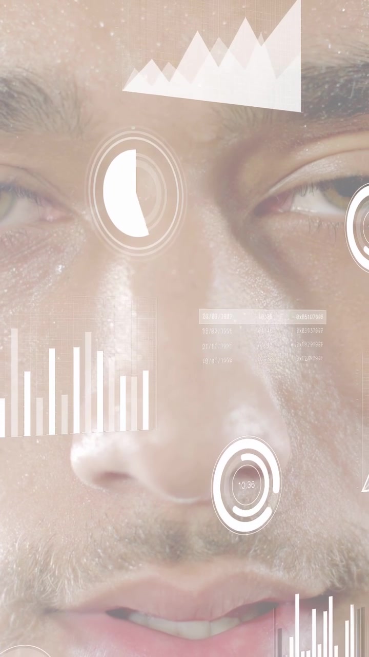 Vertical video: Man moving lips and opening eyes, speech activating tech HUD with charts for demo