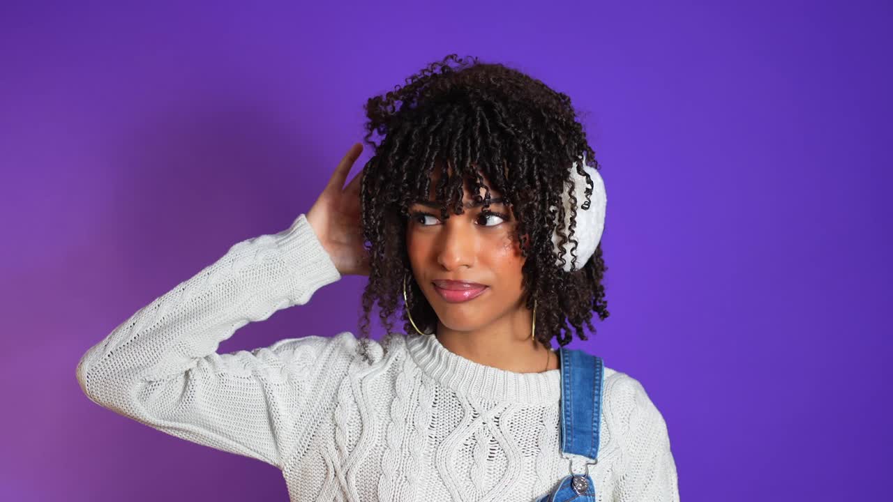 Woman with Curly Hair Listening to Headphones