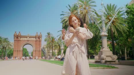 Focused-woman-looking-mobile-phone-near-monument.-Happy-couple-hugging-outdoor